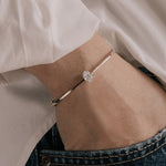 Oval cut lab grown diamond solitaire bangle in 18K yellow gold from tinxx, worn on model.