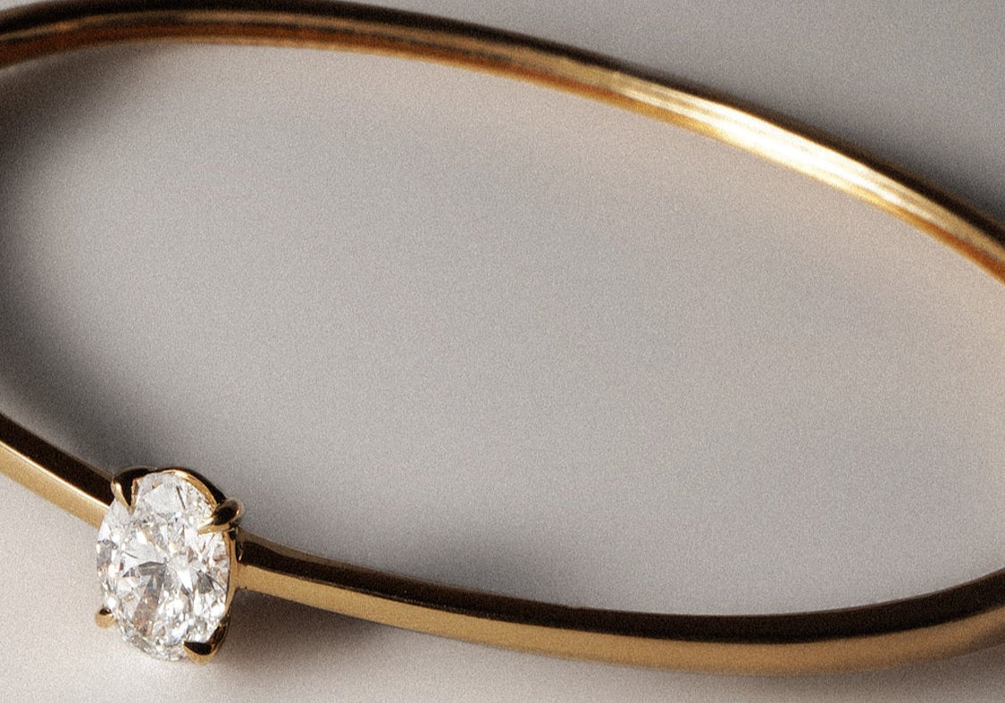 Oval cut lab grown diamond solitaire bangle in 18K yellow gold from tinxx.