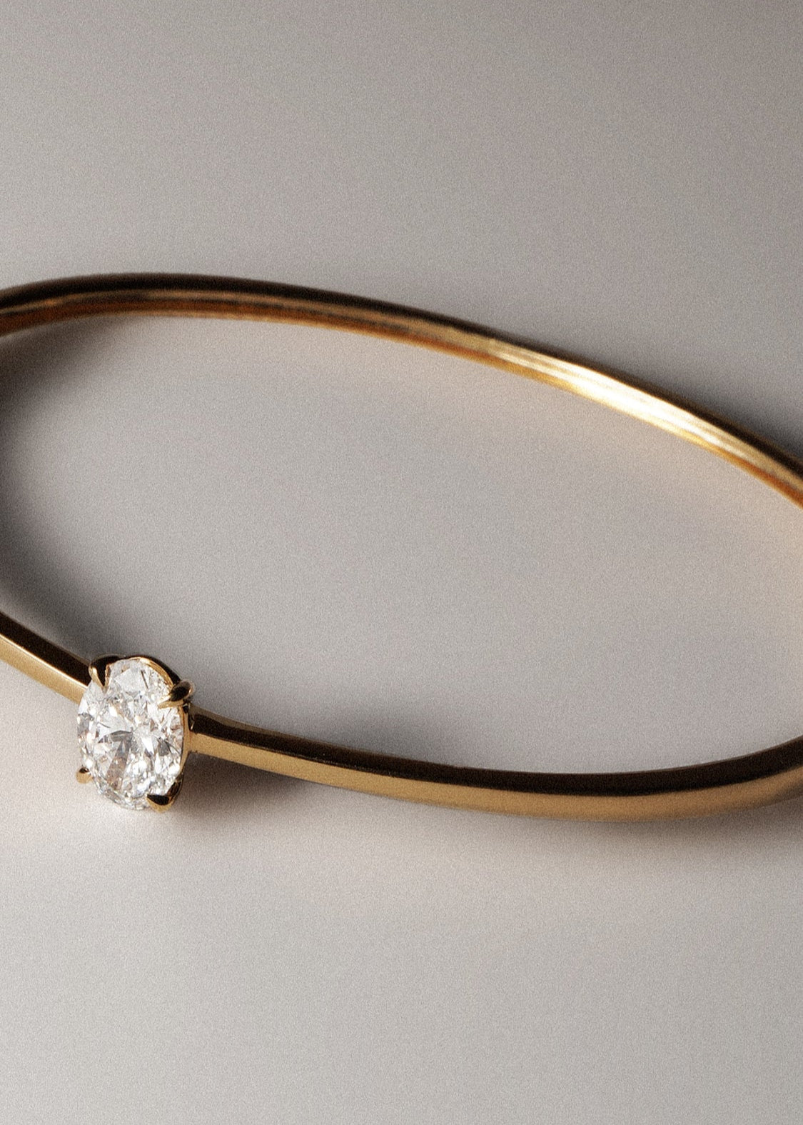 Oval cut lab grown diamond solitaire bangle in 18K yellow gold from tinxx.