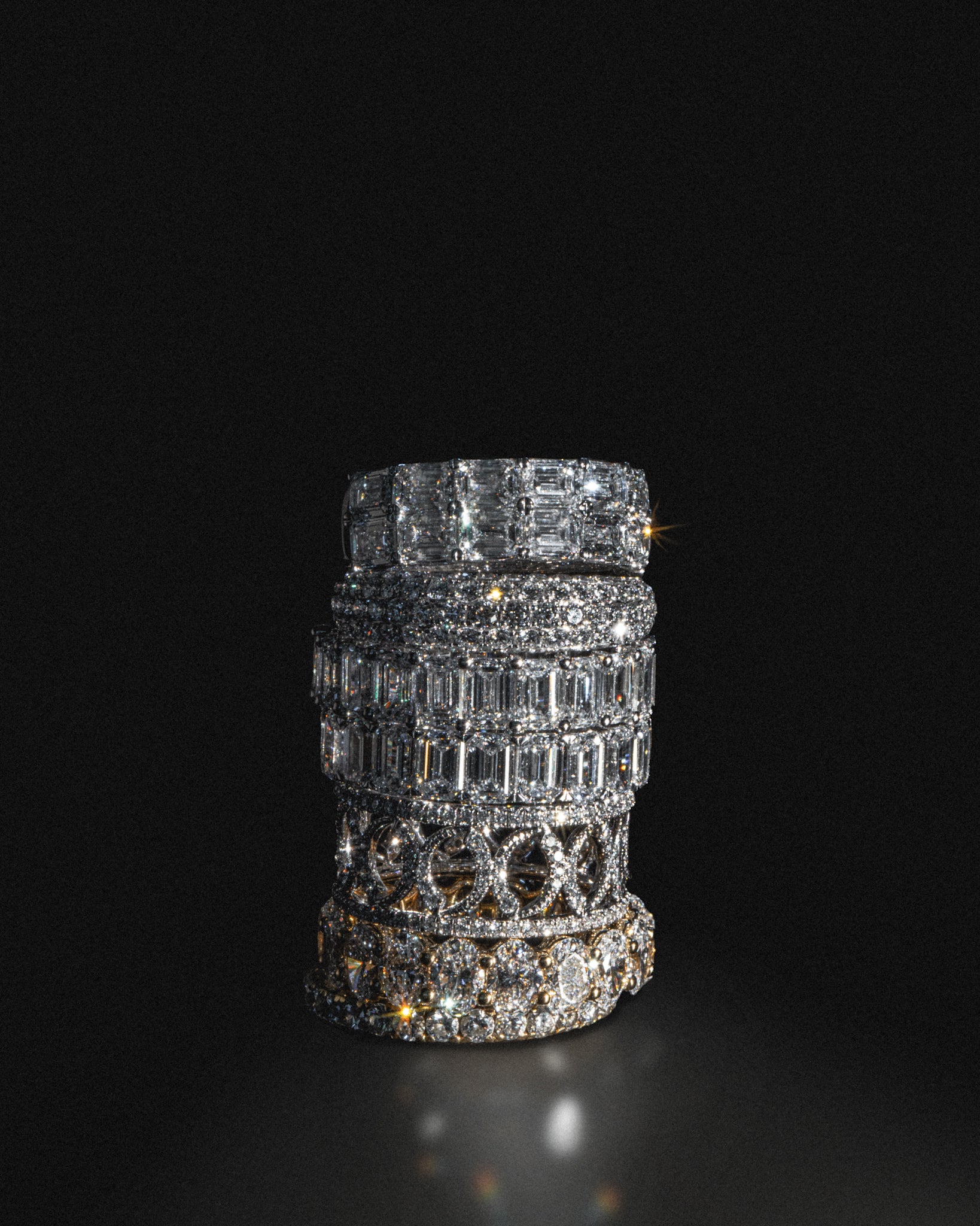 Stack of lab-grown diamond eternity rings in 18K white gold, photographed on a black background